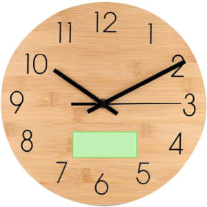 A round bamboo wall clock featuring black numbers and hands, and a green blank area.