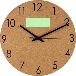 A round cork wall clock featuring bold black numerals and hands, with a blank green label at the top.