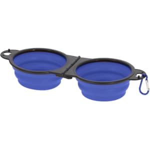 A foldable pet bowl with two blue compartments attached by a black frame and a carabiner for carrying.