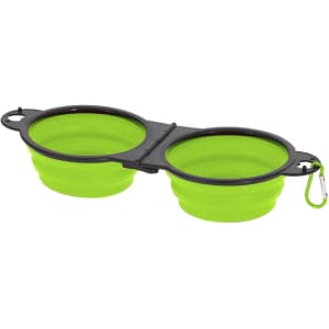 A foldable bowl in bright green colour with a black hinge and a carabiner for easy attachment.