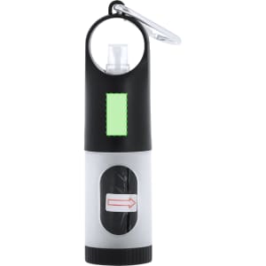 A black and grey waste bag dispenser with a carabiner clip and a logo. It has a cavity for storing waste bags.
