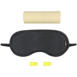 A black sleep mask, yellow earplugs, and a cylindrical container in a simple arrangement. The set has branding.