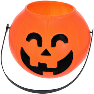 An orange Halloween basket in the shape of a pumpkin with a smiling face and a black handle.
