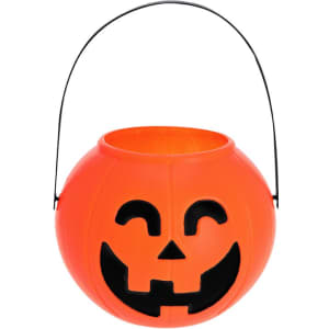 An orange pumpkin-shaped Halloween basket with a smiling jack-o'-lantern face and a black handle.