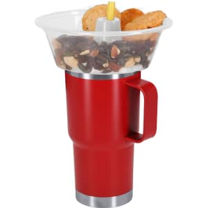 A red drink bottle with a large, clear snack bowl on top, containing nuts and biscuits.