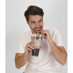 A drink bottle with a transparent design containing dark and light beverages, featuring a straw and held by a smiling man.