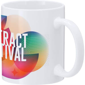 A white coffee mug with a vibrant, abstract design featuring multicoloured shapes and a logo.