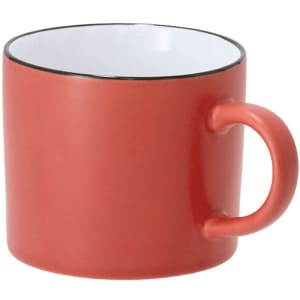 A coffee mug in coral red with a black rim and a rounded handle. It features a smooth, glossy finish.