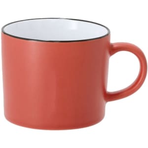 A coffee mug in coral red with a white interior and black rim, featuring a handle and a simple design.