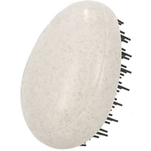A beige anti-tangle hairbrush with black bristles, featuring a minimalistic design and a branding logo.