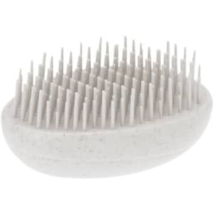 A hairbrush in a light grey colour with numerous fine bristles, featuring an ergonomic oval shape and a logo.