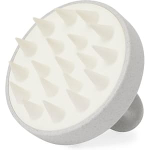 A scalp massager featuring a grey handle and white silicone bristles, designed for hair and beauty care.
