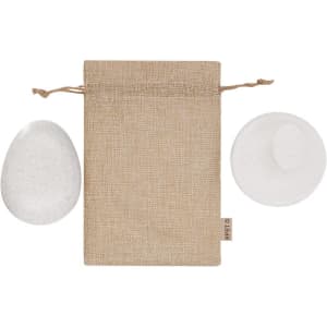 A natural canvas pouch with two smooth stones beside it, showcasing a minimalist design in neutral tones.