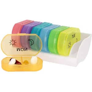 A multicoloured pillbox with compartments for each day of the week, featuring a white storage tray.