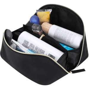 A black toiletry bag filled with various beauty products, including bottles and tubes of skincare items, neatly organised.