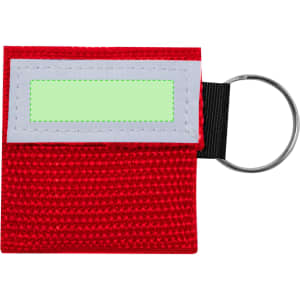 A red CPR mask keychain with a grey accent and a silver keyring attachment. Features a blank area for labelling.