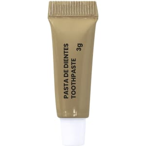 A small gold tube of toothpaste with a white cap, featuring text in English and Spanish.