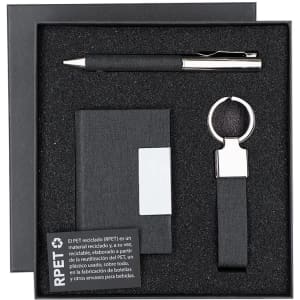 A black gift set featuring a pen, keyring, and notepad, all presented in a black box with an interior foam insert.