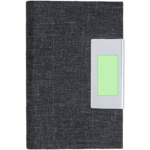 A dark grey notebook with a silver clip and a green placeholder. The notebook has a textured cover.