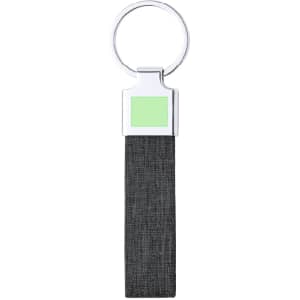 A keyring with a metal top and a black fabric strap, featuring a green accent. It has a logo on the metal part.