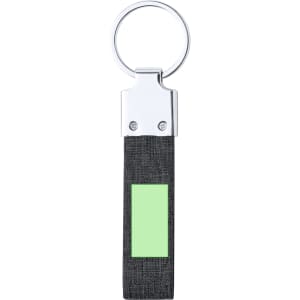 A keyring with a silver metal ring and a black fabric strap featuring a green rectangular patch.