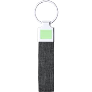 A black fabric keyring with a silver metal ring and a green square section. It features a branding logo.