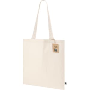 A cream tote bag with long handles and a tag, featuring a logo on one side.