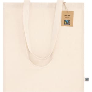 A cream-coloured tote bag with long handles and a tag, featuring a logo.