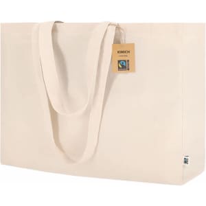A cream-coloured tote bag with two handles and a tag, featuring a logo. It is spacious and made from Fairtrade materials.