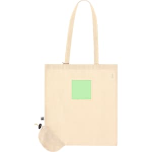 A beige foldable tote bag with a green square and a small attached pouch. It features a logo.