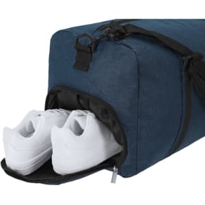 A duffle bag in navy blue, featuring a compartment with white sneakers peeking out. It has a logo on the side.