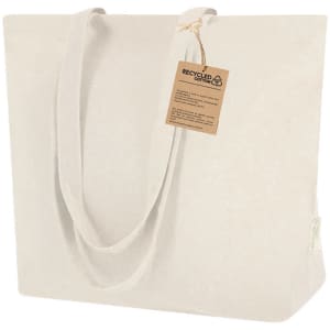 A large, natural beige tote bag made of recycled cotton, featuring sturdy handles and a label attached.