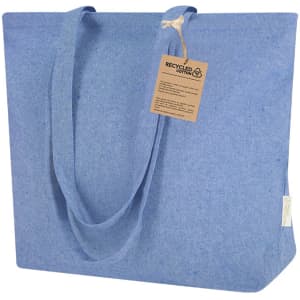 A blue tote bag made from recycled cotton, featuring sturdy handles and a tag attached.