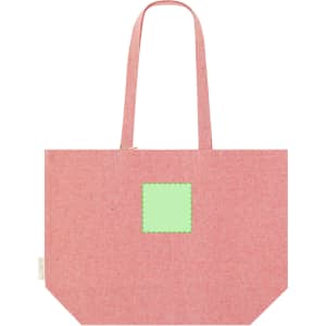 A pink tote bag with long handles and a prominent green square patch. It features a logo on one side.