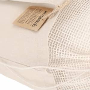 A beige tote bag with a mesh section and a tag, featuring natural fibres. The bag includes a branding logo.