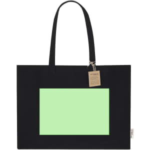 A black tote bag featuring a large green panel, with two handles and a tag attached.