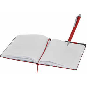 A notepad with red and black covers, featuring lined pages and a red pen placed inside.