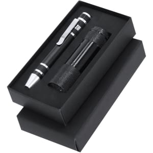 A black gift box containing a black pen and a black flashlight, each with textured grips and metal accents.