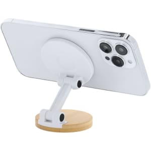 A white phone stand featuring a bamboo base, designed to hold a phone at an angle.