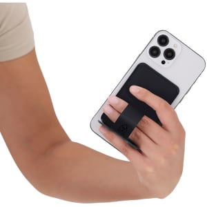 A person holding a white smartphone with a black card holder stand attached to the back.