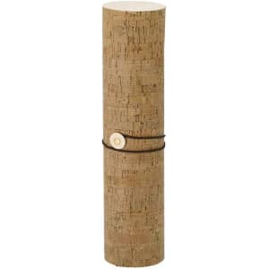 A cylindrical gift box with a cork exterior, secured with a black cord and a round wooden fastener.