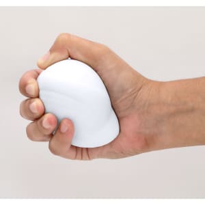 A white stress ball being squeezed in a hand, with a smooth, rounded shape. The background is neutral.