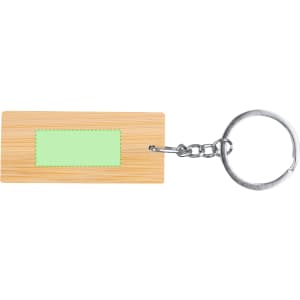 A bamboo keyring with a silver keychain and a green rectangular area for customisation.