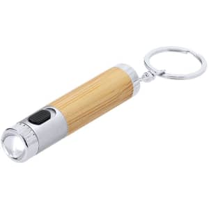 A torch keyring with a silver metal tip and a natural bamboo grip, featuring a keyring attachment.