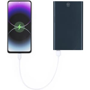 A dark blue power bank connected to a smartphone with a white charging cable. The smartphone displays a charging icon.