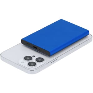 A blue power bank rests atop a silver smartphone, featuring ports on the side and a subtle branding logo.