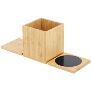 A bamboo multifunction pencil holder with a removable lid and a circular wireless charging pad included.