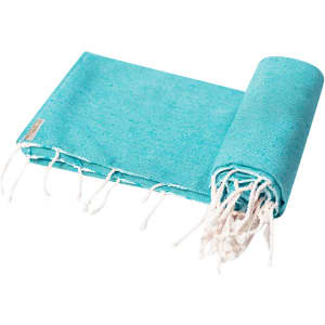 A turquoise towel pareo featuring fringe detailing and a logo, rolled up for storage or transport.