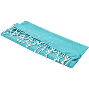 A folded aqua towel with fringe detailing, designed for leisure and outdoor beach use. It has a simple, stylish appearance.