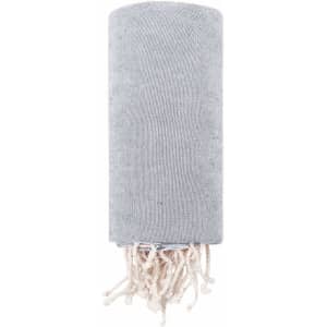 A grey towel pareo with tasselled ends, designed for leisure and outdoor use. It includes a logo.